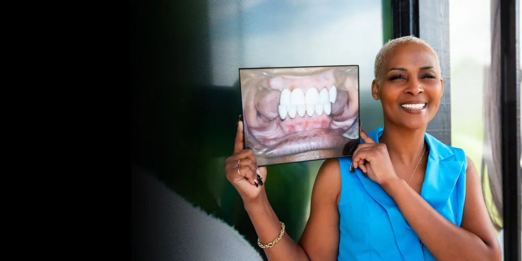 dental patient holding up before and after photo