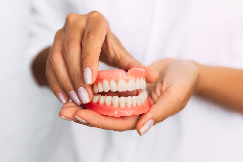 denture being held