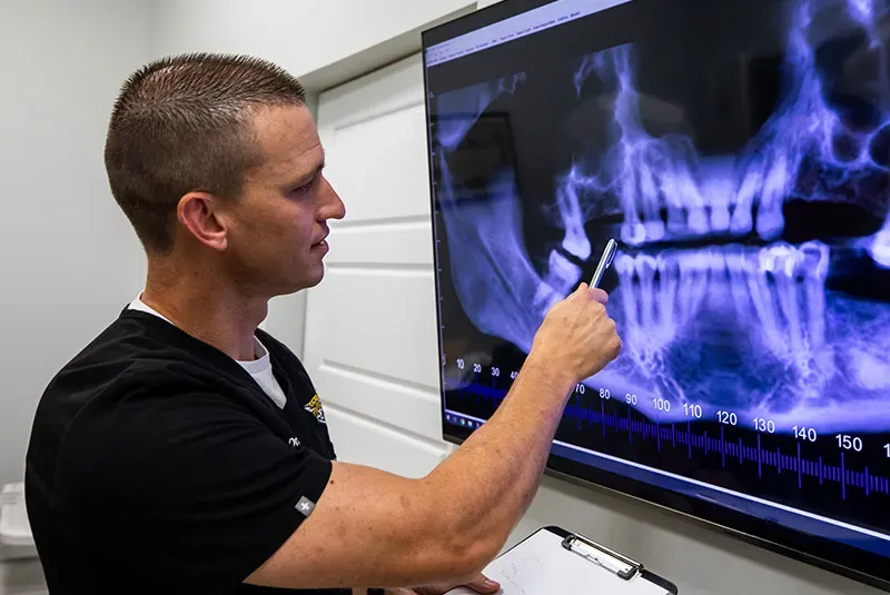 Dental professional explaining preparation steps for sedation dentistry to a patient