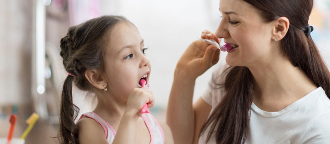 mother-and-daughter-brushing-their-teeth